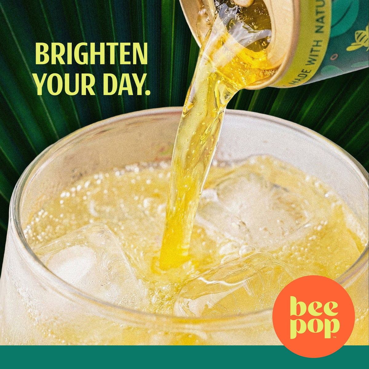 A close-up of a beverage can pouring a golden yellow drink into a clear glass with ice. Large text reads 'BRIGHTEN YOUR DAY.
