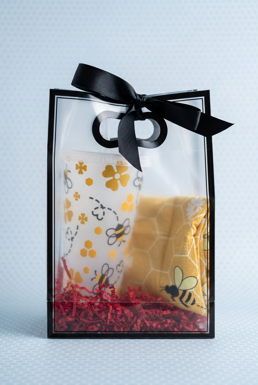Gift bag with bee themed drink cup and bee themed socks