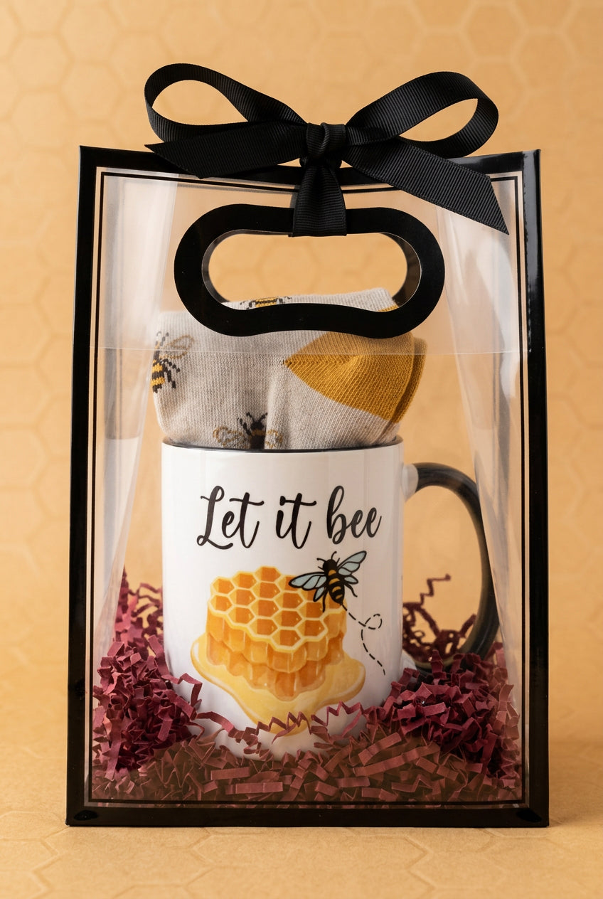 Gift bag with “let it bee” coffee cup and bee themed socks