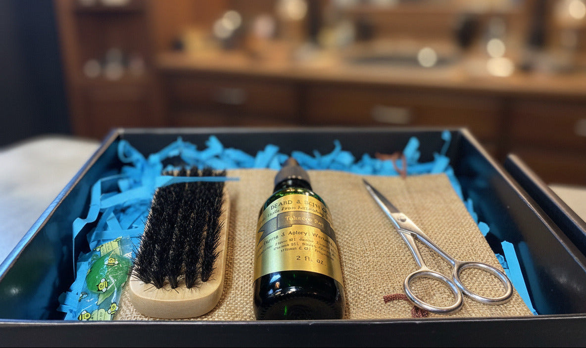 beard oil grooming set with oil, brush, and scissors